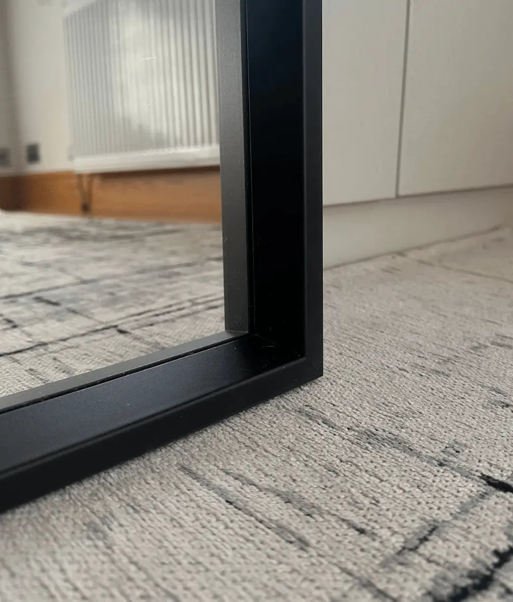 Black rectangular wall mirror with a sleek modern frame