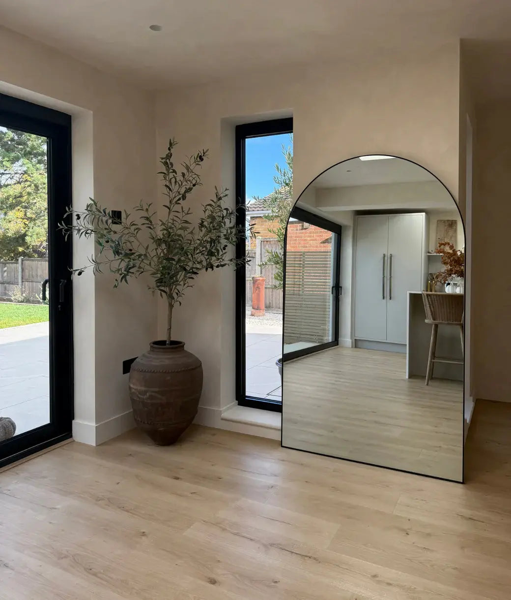 floor leaning arched mirror stylish decor