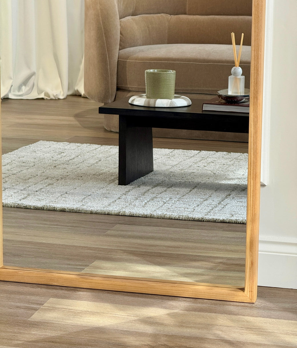 Base corner detail of natural oak wood frame on full-length leaner mirror
