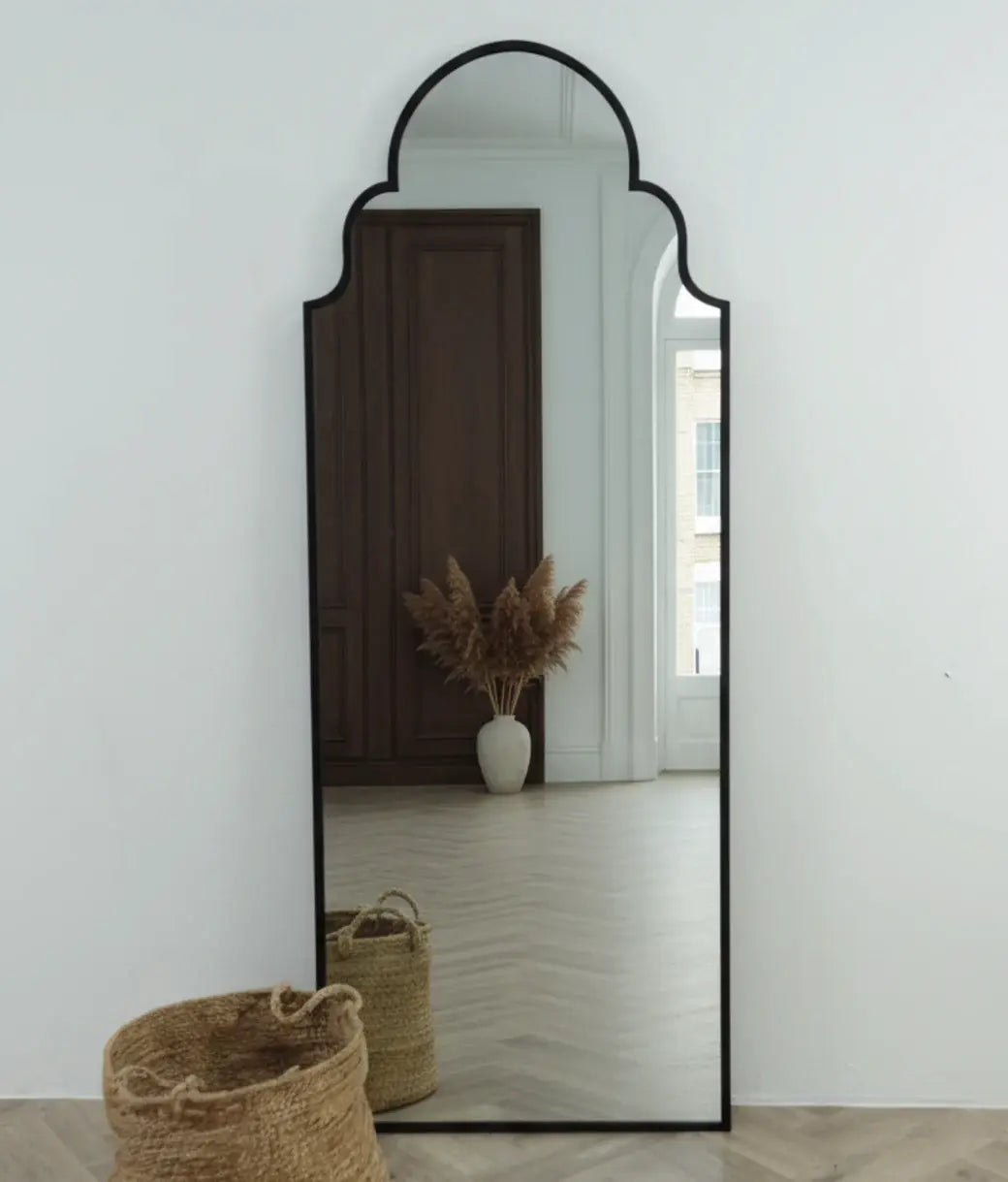Tall black arched mirror with a Moroccan